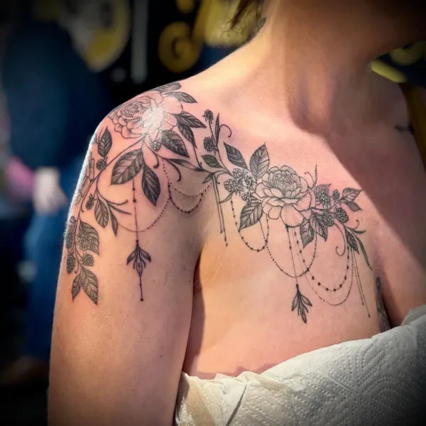 Elegant ornamental floral chest and shoulder tattoo piece